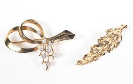 A yellow metal and diamond set brooch, stamped 9k, and a yellow metal leaf design brooch