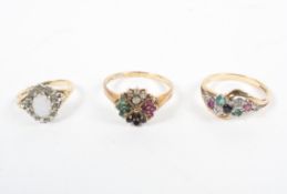 Two hallmarked diamond and gem set rings and an opal set gold dress ring,