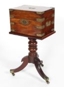 A Victorian mahogany brass campaign-style decanter box on a tripod stand,