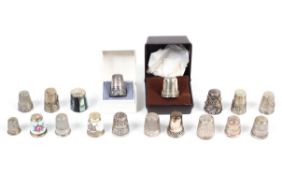 A collection of imported silver and white metal thimbles, including engraved and enamelled examples,