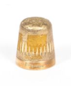 A 9ct gold thimble, with engraved and burnished decoration on a textured ground,