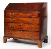 A George III mahogany bureau, the fall front enclosing a fitted interior