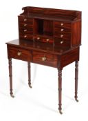 A Victorian mahogany desk, with gallery above two banks of short drawers and pigeon hole,