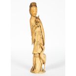 A Chinese ivory figure,19th century, of a maiden holding a peach branch,