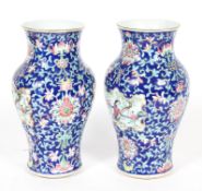 A pair of Chinese Canton baluster vases, late 19th century, painted with figures in landscapes,