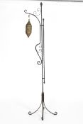 A Middle Eastern brass pierced lantern with pierced floral decoration, and wrought iron stand,