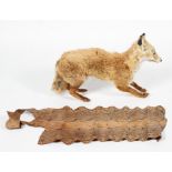 A taxidermy Red Fox together with a roll of snakeskin,