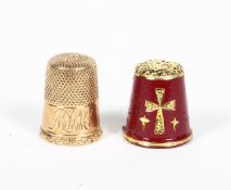 A yellow metal thimble, with scrolling initials and foliate decoration to the rim, stamped '9'