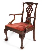 A George III mahogany armchair, the top rail carved with leaves and branches, with pierced splat,