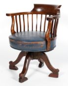 A Victorian mahogany captain's chair, late 19th century, with curved top rail and scroll arms,