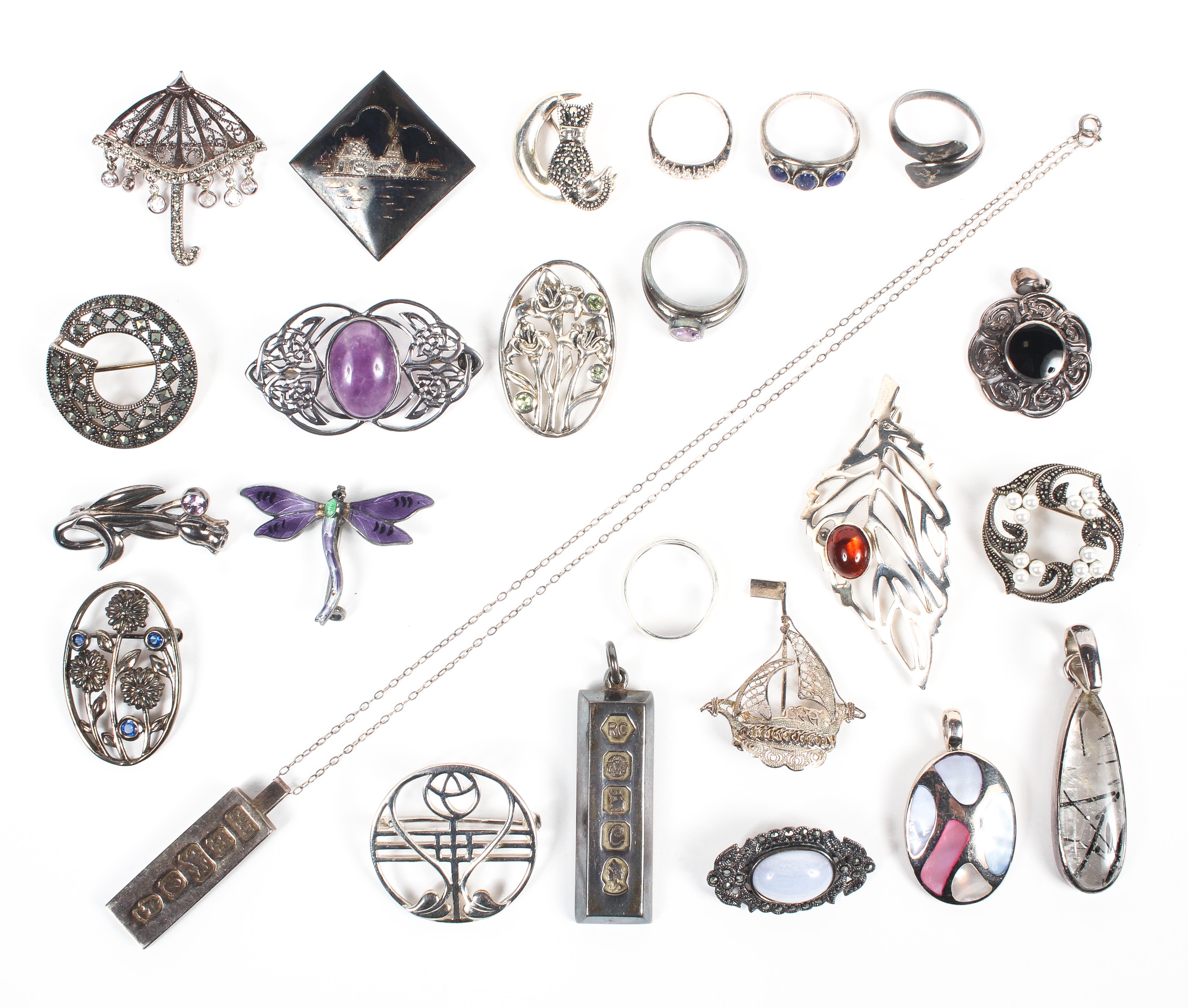 A collection of silver jewellery to include five pendants; fourteen brooches and five rings.