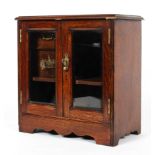 A Late Victorian oak smoker's cabinet, with two bevelled glass doors,