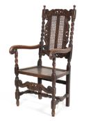 A Victorian carved oak hall chair in the Carolean style,