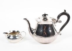 A silver teapot and a cream jug, the first hallmarked Sheffield, 1891,