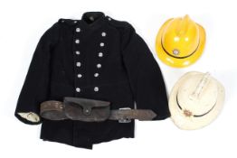 A vintage fireman's jacket together with helmet and a leather axe holder,