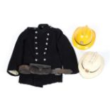 A vintage fireman's jacket together with helmet and a leather axe holder,