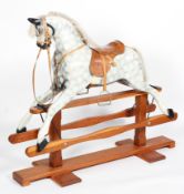 A modern rocking horse by Lusal, dappled grey with grey mane and tail,