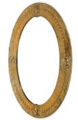 An Arts and Crafts brass oval mirror, circa 1900,