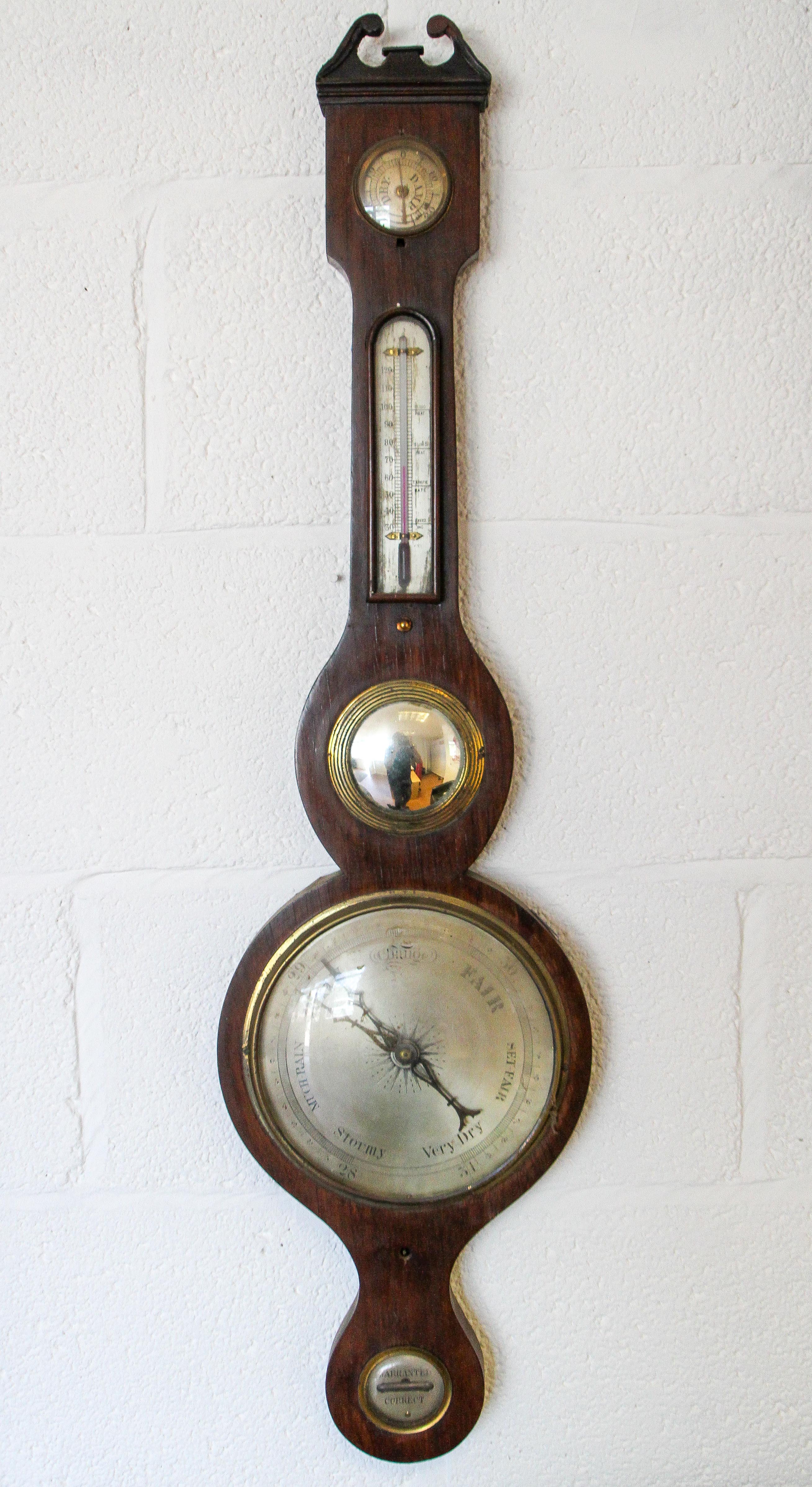 A 19th century mahogany wheel barometer, with silvered hygrometer, thermometer gauge,