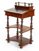 A Victorian walnut davenport, the top inset with green leather, with ball finials to gallery,