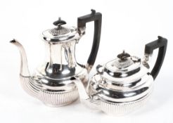 An Edwardian four piece EPNS tea service, in the Georgian style, of reeded form.