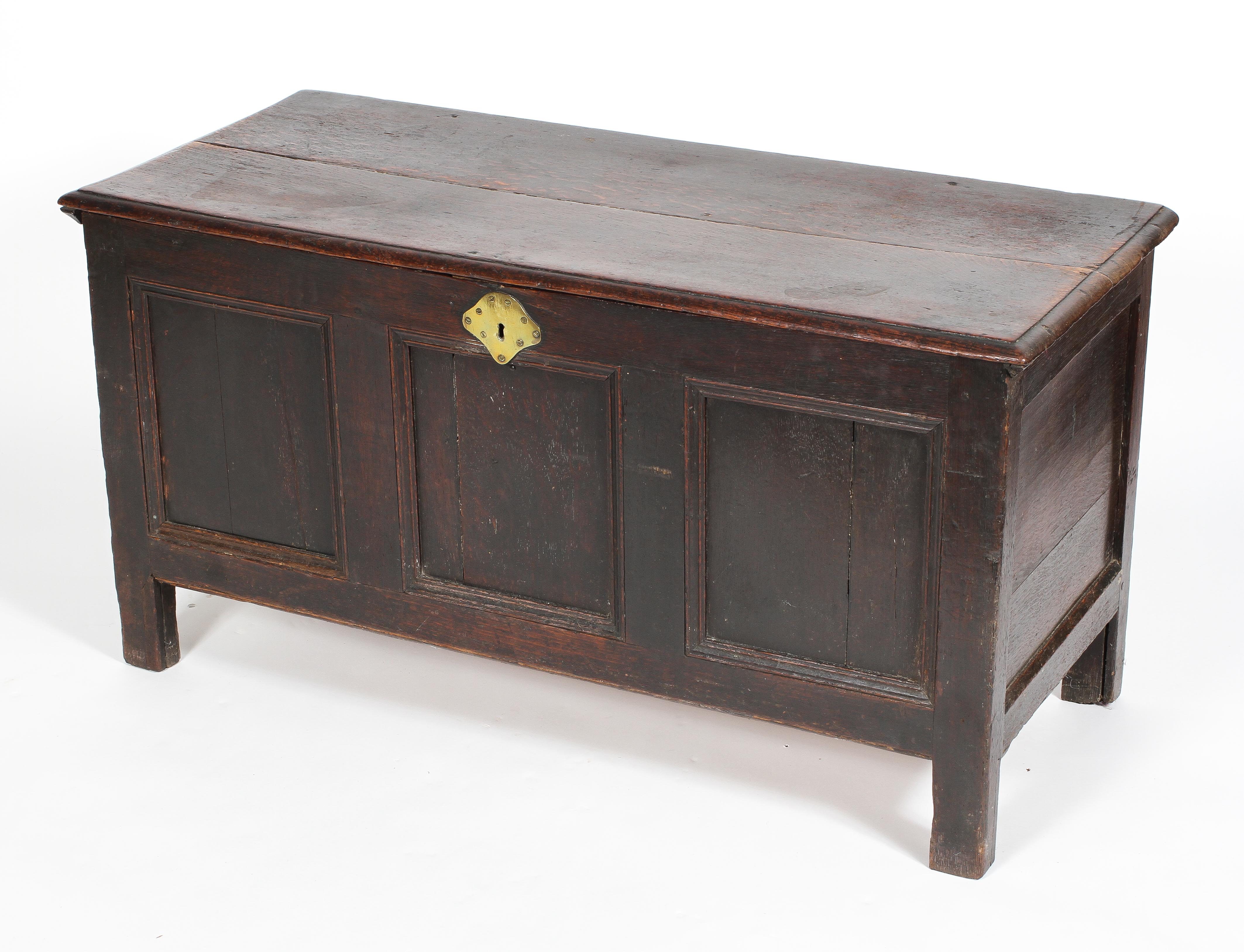 An oak coffer, late 17th or early 18th century, candle box interior and triple panel front,