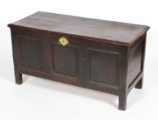 An oak coffer, late 17th or early 18th century, candle box interior and triple panel front,