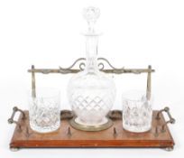 A Victorian oak and brass-mounted pipe rack and a decanter stand,