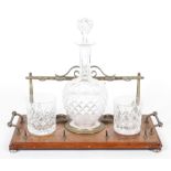 A Victorian oak and brass-mounted pipe rack and a decanter stand,