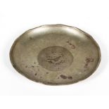 A Chinese white metal dish, the centre set with a a coin, marked HC and a single character