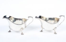 A pair of silver sauce boats, ribbed edge with acanthus leaf motif to handle top,