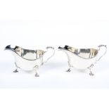 A pair of silver sauce boats, ribbed edge with acanthus leaf motif to handle top,