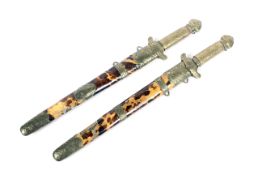 A pair of oriental short daggers, each with tortoiseshell inlaid scabbards,