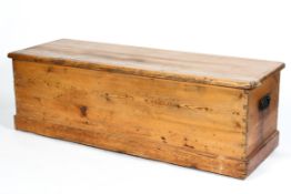 A 19th century rectangular pine trunk, with swing handles, on plinth base,