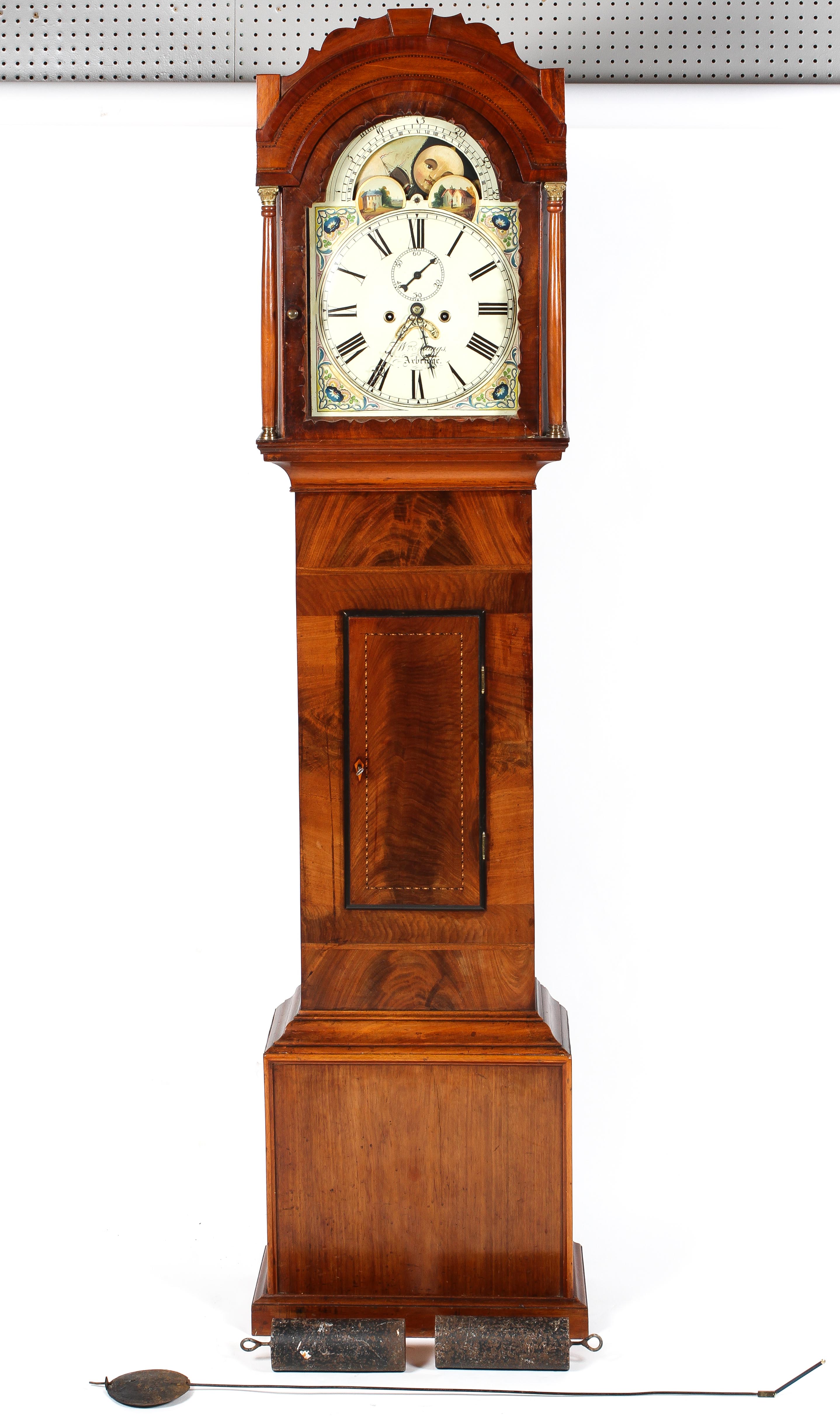 A mahogany and walnut long case clock, the 11" painted dial with floral spandrels,