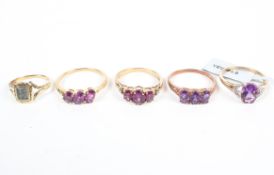 A collection of four gemstone set dress rings, each marked for 9ct gold with a mourning ring