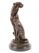 'Milo', An art deco style seated cheetah, bronze, signed to base, on a black marble foot,