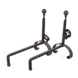 A pair of iron fire dogs, each with ball finials and pierced cross ornament to adjustable support,