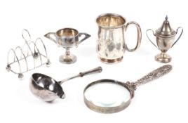 A selection of silver wares, including a Georgian toddy ladle bowl, four slice toast rack,