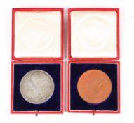 Two Victoria 1837-1897 medals, TB initials, one with a terracotta colour patination,