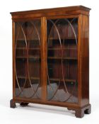A George III style mahogany glazed bookcase, with two doors with ovolo-shaped astragals,
