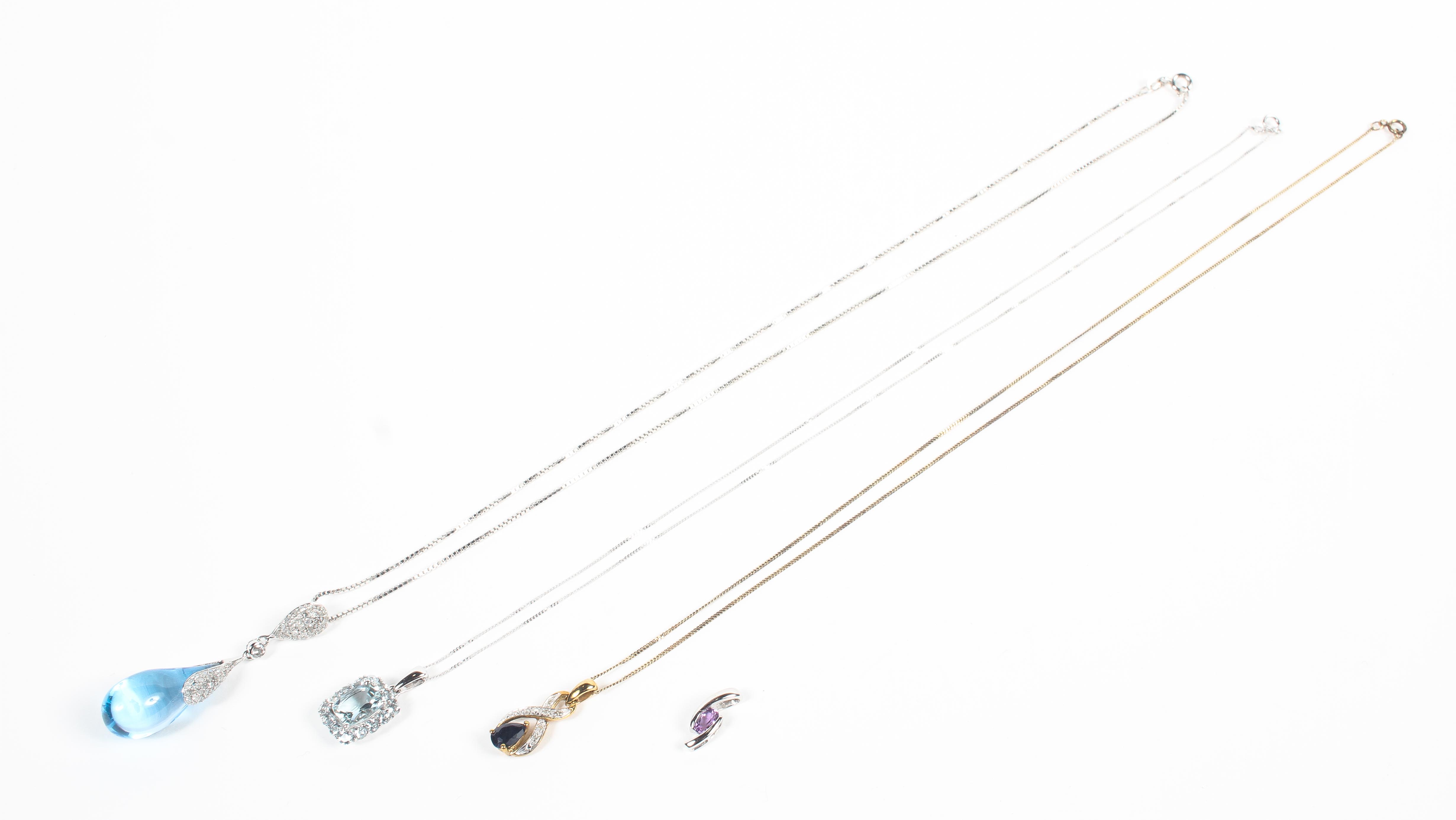 A collection of three gold gemstone and diamond pendants together with a white gold amethyst pendant