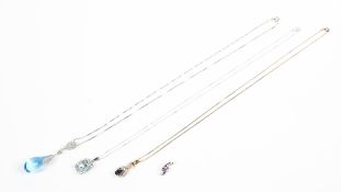 A collection of three gold gemstone and diamond pendants together with a white gold amethyst pendant