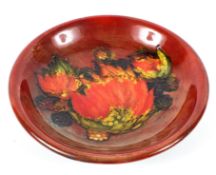 A Moorcroft Leaf and Berry flambe shallow circular dish, circa 1934,