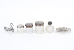 Six silver and white metal topped cut-glass bottles, Victorian and later, comprising: three jars,