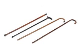 A collection of four antique walking sticks, comprising: three mallaca and one ebonised example,