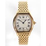 An 18ct gold ladies Cartier quartz wristwatch. Tonneau white dial with roman numerals.