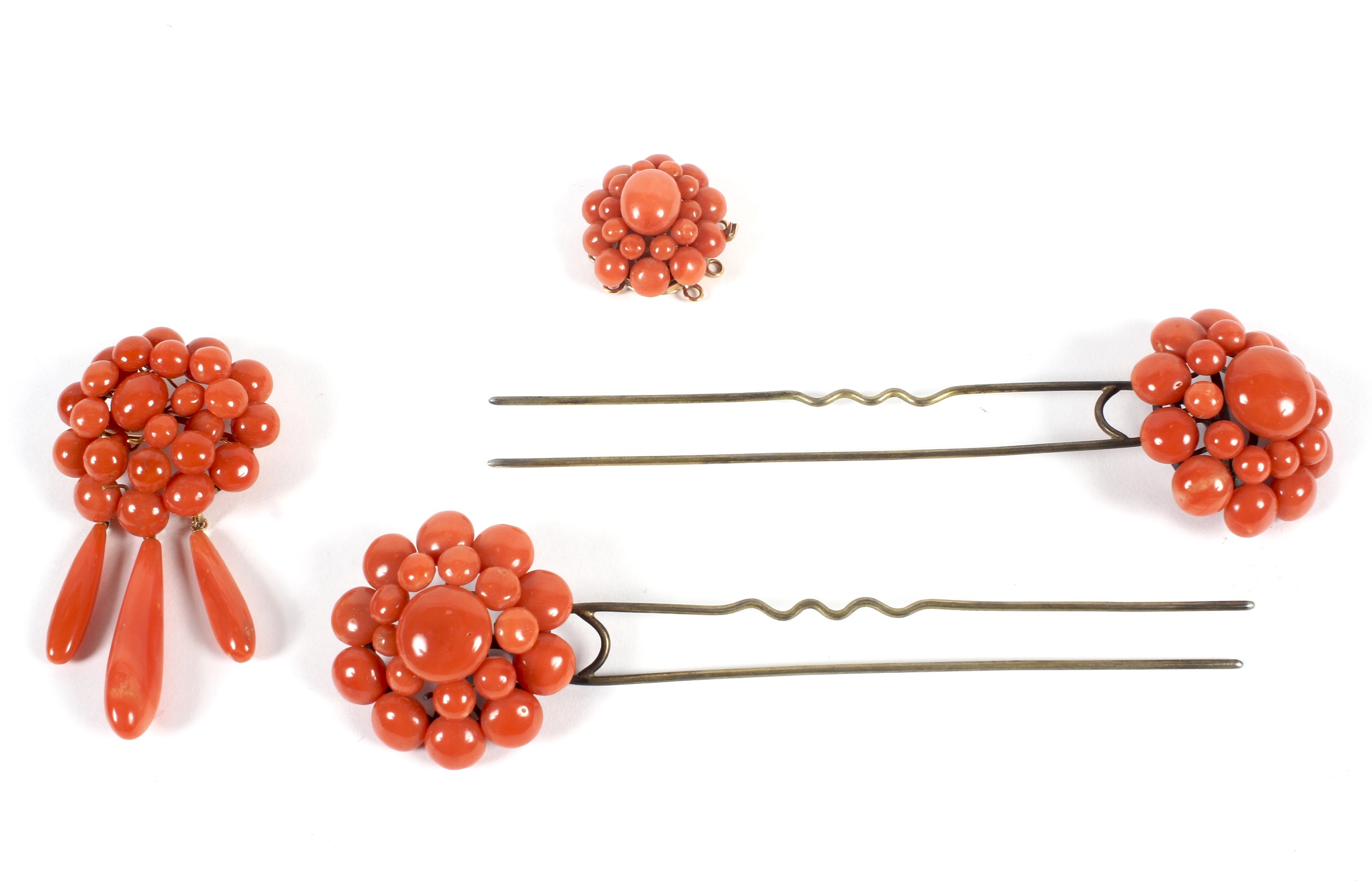 A set of 20th Century coral jewellery, comprising a locket and brooch mounted in yellow metal,