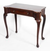 A George III mahogany side table, with shaped square top above frieze drawer,