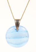 A circular blue glass pendant suspended from a hallmarked 9ct 24 inch curb chain